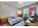 Neutral bedroom featuring a twin bed, desk, and window with blind coverings at 2024 Woodshorn Dr, Matthews, NC 28104