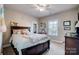 Bedroom featuring a large bed, a ceiling fan, and a window with blinds at 2024 Woodshorn Dr, Matthews, NC 28104