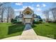 Elegant clubhouse with stone accents, manicured landscaping, and inviting entrance, enhancing the community's appeal at 2024 Woodshorn Dr, Matthews, NC 28104
