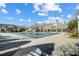 Spacious community pool covered for the off-season, next to a pool deck with furniture, enhancing the community's appeal at 2024 Woodshorn Dr, Matthews, NC 28104