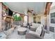 Charming covered patio with ceiling fans, outdoor seating, and a stone fireplace at 2024 Woodshorn Dr, Matthews, NC 28104