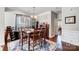 Elegant dining room with a wooden table, seating for six, and wine storage at 2024 Woodshorn Dr, Matthews, NC 28104