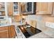 Close up of a kitchen with granite countertops, stainless steel appliances, and custom cabinetry at 2024 Woodshorn Dr, Matthews, NC 28104