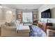 Bright living room featuring a large sectional, stylish decor, and a flat-screen TV at 2024 Woodshorn Dr, Matthews, NC 28104