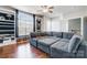 Comfortable living room featuring large sectional seating with hardwood flooring and large windows at 2024 Woodshorn Dr, Matthews, NC 28104
