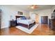 Spacious main bedroom with hardwood floors, ceiling fan, and decorative details at 2024 Woodshorn Dr, Matthews, NC 28104