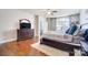 Comfortable main bedroom with a ceiling fan, large window, and dresser with a TV at 2024 Woodshorn Dr, Matthews, NC 28104