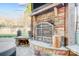 Inviting outdoor stone fireplace with a mounted television for cozy evenings at 2024 Woodshorn Dr, Matthews, NC 28104