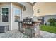 An outdoor kitchen featuring a stainless steel grill and stone accents at 2024 Woodshorn Dr, Matthews, NC 28104