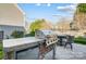 A fully equipped outdoor kitchen with a built-in grill and bar seating area at 2024 Woodshorn Dr, Matthews, NC 28104