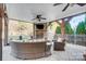 Cozy covered patio with a stone fireplace, a TV, and wicker seating at 2024 Woodshorn Dr, Matthews, NC 28104