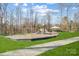 Community playground with slides, climbing structures, and a gazebo in a wooded area at 2024 Woodshorn Dr, Matthews, NC 28104