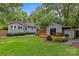 Serene backyard featuring a shed with a deck, stone pathway, and green lawn at 2115 Laburnum Ave, Charlotte, NC 28205