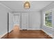 Spacious bedroom featuring hardwood floors, natural light, and neutral color palette at 2115 Laburnum Ave, Charlotte, NC 28205