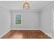 Spacious bedroom featuring hardwood floors, natural light, and neutral color palette at 2115 Laburnum Ave, Charlotte, NC 28205