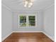 Bedroom with hardwood floors, fresh paint, and natural light from the large window at 2115 Laburnum Ave, Charlotte, NC 28205