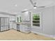 Bright kitchen featuring stainless steel appliances, white cabinets, stone countertops and backyard views at 2115 Laburnum Ave, Charlotte, NC 28205