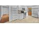 Contemporary kitchen with stainless steel appliances, white cabinets, and tile flooring, perfect for cooking enthusiasts at 2115 Laburnum Ave, Charlotte, NC 28205