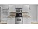 Well-equipped kitchen with stainless steel appliances, granite counters and white cabinetry at 2115 Laburnum Ave, Charlotte, NC 28205