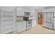 This modern kitchen offers stainless steel appliances, white cabinets, and tile flooring at 2115 Laburnum Ave, Charlotte, NC 28205