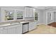This is a close view of the kitchen sink with stainless steel dishwasher and neutral countertops at 2115 Laburnum Ave, Charlotte, NC 28205