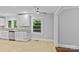 Well-lit kitchen with stainless steel appliances, white cabinets, and bright windows overlooking the outdoors at 2115 Laburnum Ave, Charlotte, NC 28205