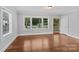 Bright living room with hardwood floors, large windows, and an open doorway at 2115 Laburnum Ave, Charlotte, NC 28205