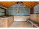 Shed interior with wooden walls, workbench, and storage at 2115 Laburnum Ave, Charlotte, NC 28205