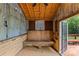 Shed interior with wooden walls, bench, and door to backyard deck at 2115 Laburnum Ave, Charlotte, NC 28205