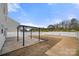 Wide backyard with a pergola on the concrete patio and a white fence surrounding property at 225 Final Stretch Ln, Clover, SC 29710