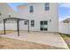 Backyard view, showcasing concrete patio, pergola, and sliding glass doors to access indoor living spaces at 225 Final Stretch Ln, Clover, SC 29710