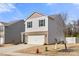 Charming two-story home featuring a brick-accented facade, attached two-car garage, and lovely curb appeal at 225 Final Stretch Ln # 19, Clover, SC 29710