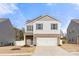 Charming two-story home featuring a brick-accented facade, attached two-car garage, and lovely curb appeal at 225 Final Stretch Ln, Clover, SC 29710
