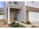 Charming front door with glass detailing and brick accents, enhancing the home's curb appeal at 225 Final Stretch Ln # 19, Clover, SC 29710