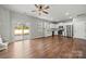 Open concept kitchen with stainless steel appliances, white cabinets and living space with hardwood floors at 225 Final Stretch Ln, Clover, SC 29710