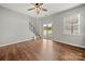 Bright living room features hardwood floors, staircase, and sliding glass doors to the backyard at 225 Final Stretch Ln, Clover, SC 29710