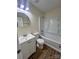 Well-lit bathroom includes a white vanity, toilet, and tub with shower at 2303 Hope Valley Ln, Charlotte, NC 28213