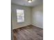 Bedroom with wood-look flooring and window letting in natural light at 2303 Hope Valley Ln, Charlotte, NC 28213