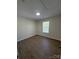 Bedroom with a window and modern flooring at 2303 Hope Valley Ln, Charlotte, NC 28213