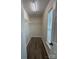 Walk-in closet with ample shelving, hardwood floors, and natural light from the window at 2303 Hope Valley Ln, Charlotte, NC 28213