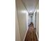 Well-lit hallway with hardwood flooring, white trim, and multiple doorways at 2303 Hope Valley Ln, Charlotte, NC 28213