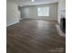Spacious living room with wood floors, a fireplace, and ample natural light at 2303 Hope Valley Ln, Charlotte, NC 28213
