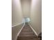 Bright staircase with hardwood steps and a white railing leading to the upper level at 2303 Hope Valley Ln, Charlotte, NC 28213