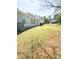 This backyard has ample grass and is surrounded by a wood fence at 2307 Hope Valley Ln, Charlotte, NC 28213