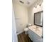Bathroom featuring modern vanity, updated fixtures, and wood-look flooring at 2307 Hope Valley Ln, Charlotte, NC 28213
