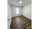 This bedroom features vinyl floors, a window, and a ceiling skylight at 2307 Hope Valley Ln, Charlotte, NC 28213