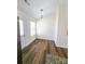 Dining room with wood-look flooring, modern lighting and natural light at 2307 Hope Valley Ln, Charlotte, NC 28213