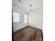 Bright dining room with wood-look flooring and contemporary lighting at 2307 Hope Valley Ln, Charlotte, NC 28213