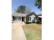 This charming one-story home has a well-manicured front lawn and a concrete driveway at 2307 Hope Valley Ln, Charlotte, NC 28213