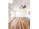 Spacious living room featuring wood-look flooring, natural light and fan at 2307 Hope Valley Ln, Charlotte, NC 28213
